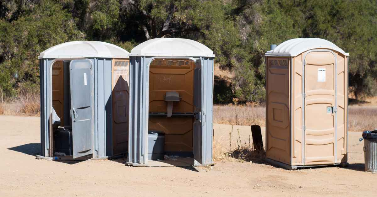 How are portable toilets emptied?